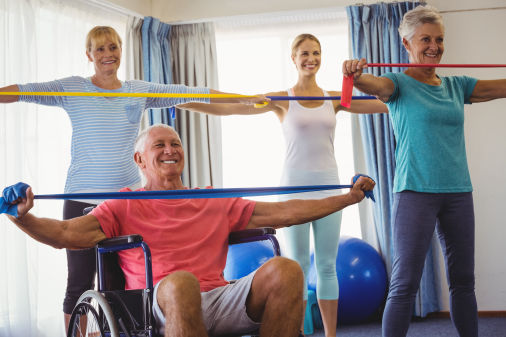 Seniors stretching during fitness class in retirement house